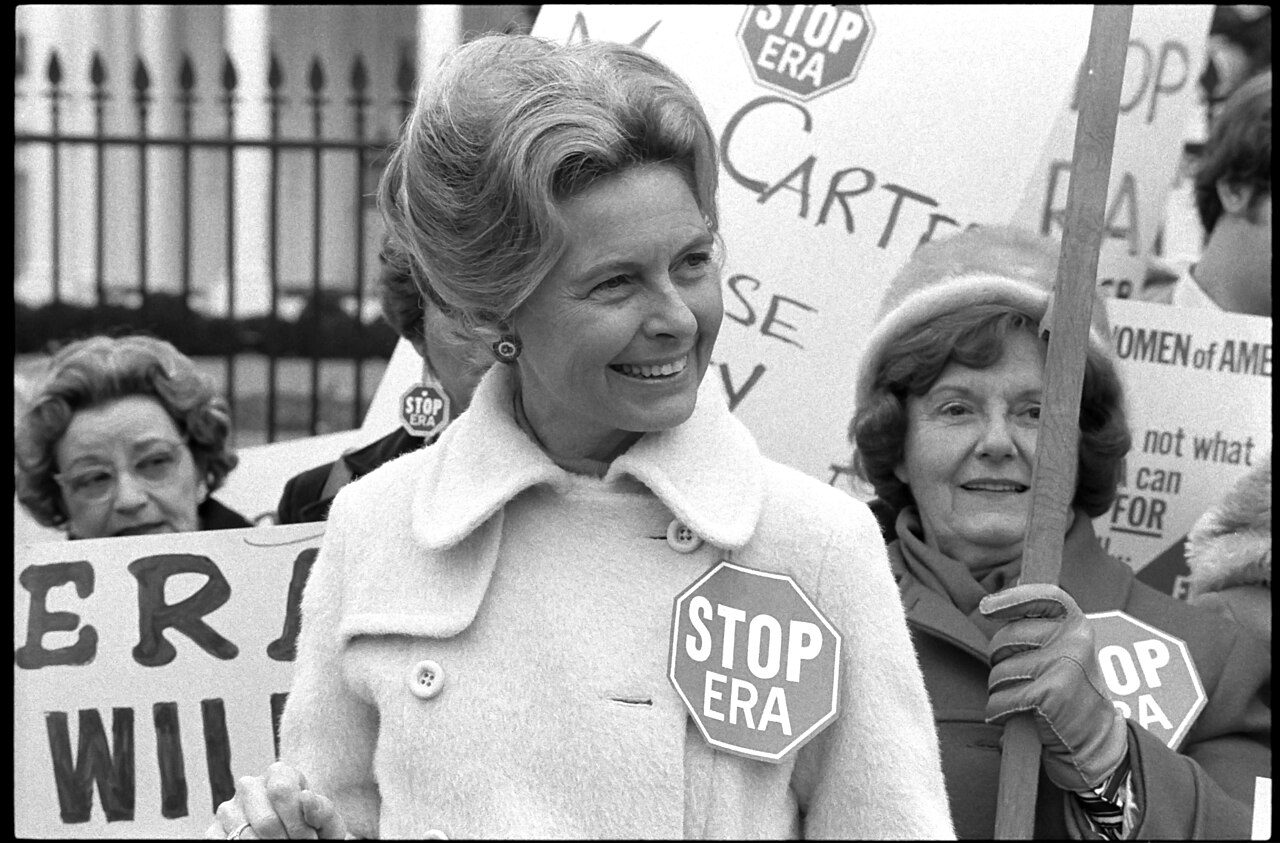 Activist Phyllis Schafly wearing a "Stop ERA" badge, demonstrating with other women against the Equal Rights Amendment in front of the White House, Washington, D.C.