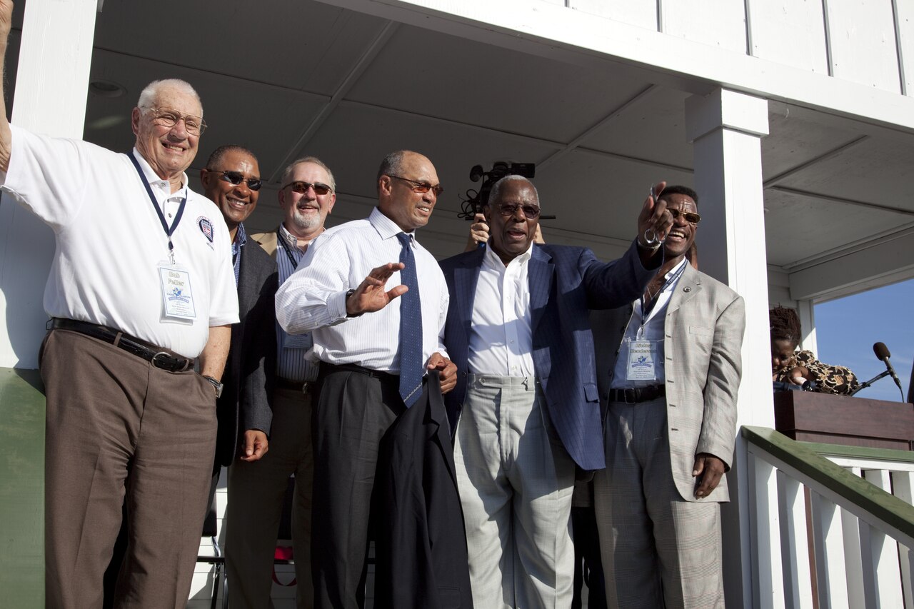 Bob Feller, Ozzie Smith, Bruce Sutter, Reggie Jackson, Hank Aaron and Rickey Henderson wave to the crowd on the porch of Hank Aaron boyhood home at the Dedication ceremony at the Hank Aaron Stadium, LCCN2010638103