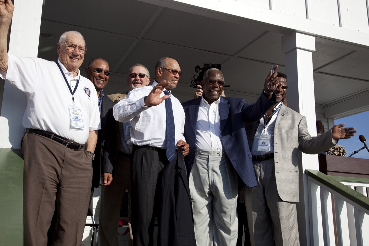 Bob Feller, Ozzie Smith, Bruce Sutter, Reggie Jackson, Hank Aaron and Rickey Henderson wave to the crowd on the porch of Hank Aaron boyhood home at the Dedication ceremony at the Hank Aaron Stadium, LCCN2010638104