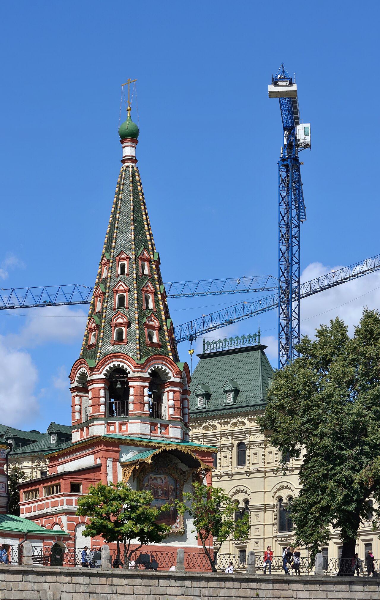 Bell tower of St Basil Cathedral in Moscow and tower cranes
