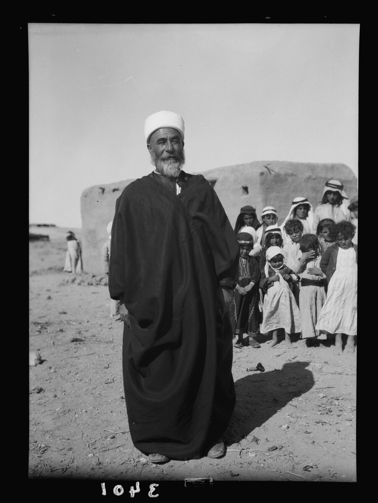 El-Azrak & Wadi Sirhan in the Arabian Desert. Druse (i.e., Druze) political refugees from Jebel Druse (The Hauran). A Druse school. Mud hut, teacher and class in Wadi Sirhan LOC matpc.15320