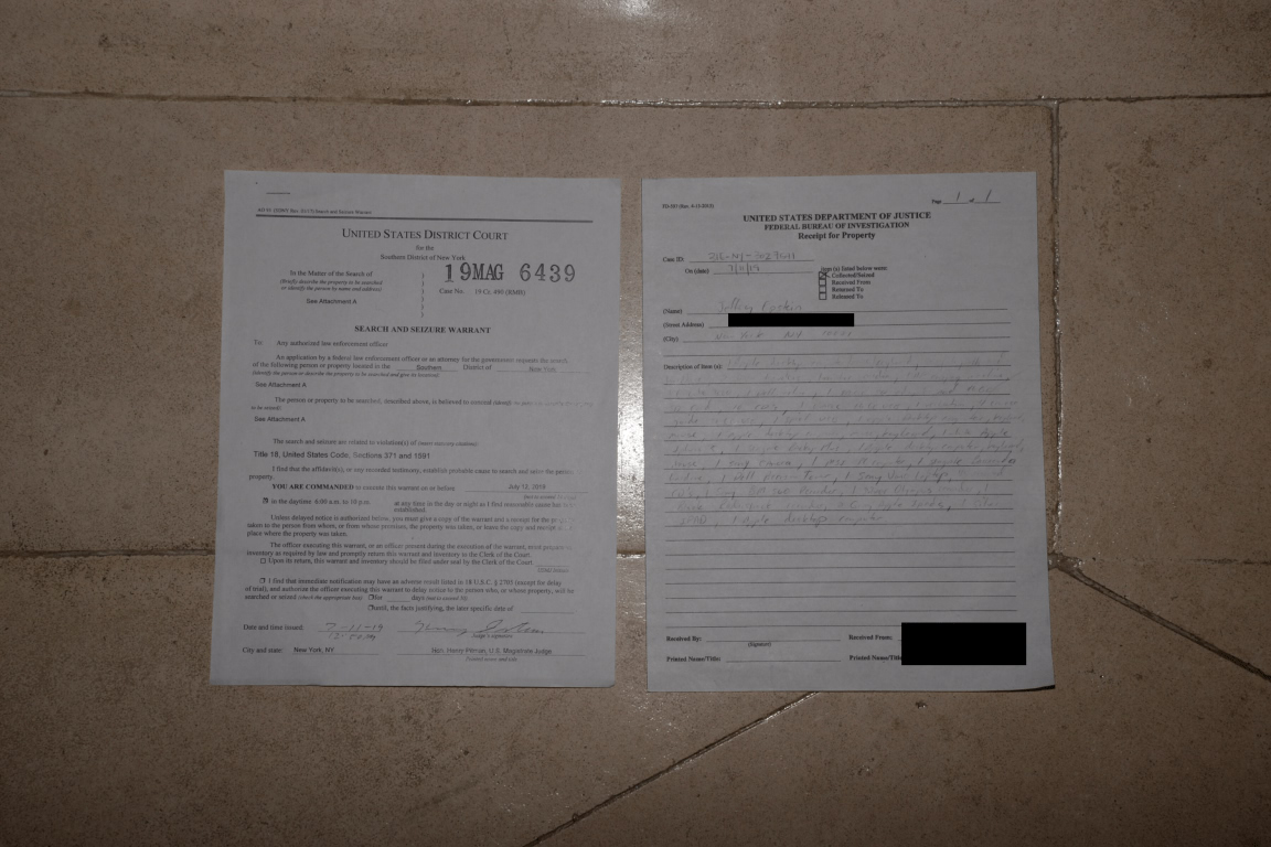 EFTA00001499 - Two legal documents a search and seizure warrant and a federal investigation report are displayed on a tiled wall