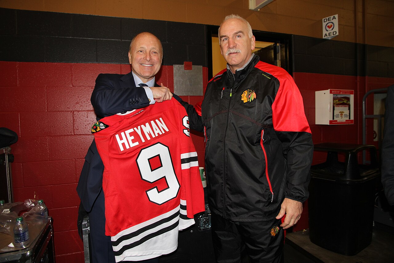 Chicago Blackhawks coach, Joel Quenneville, presents U.S. Ambassador to Canada Bruce Heyman with an official Blackhawks jersey.