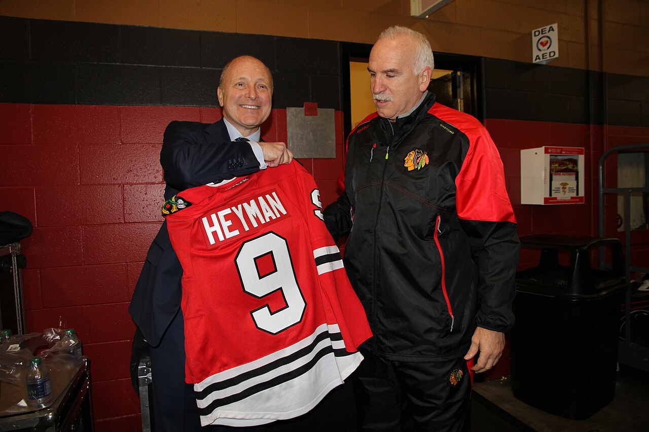 Chicago Blackhawks coach, Joel Quenneville, presents U.S. Ambassador to Canada Bruce Heyman with an official Blackhawks jersey.