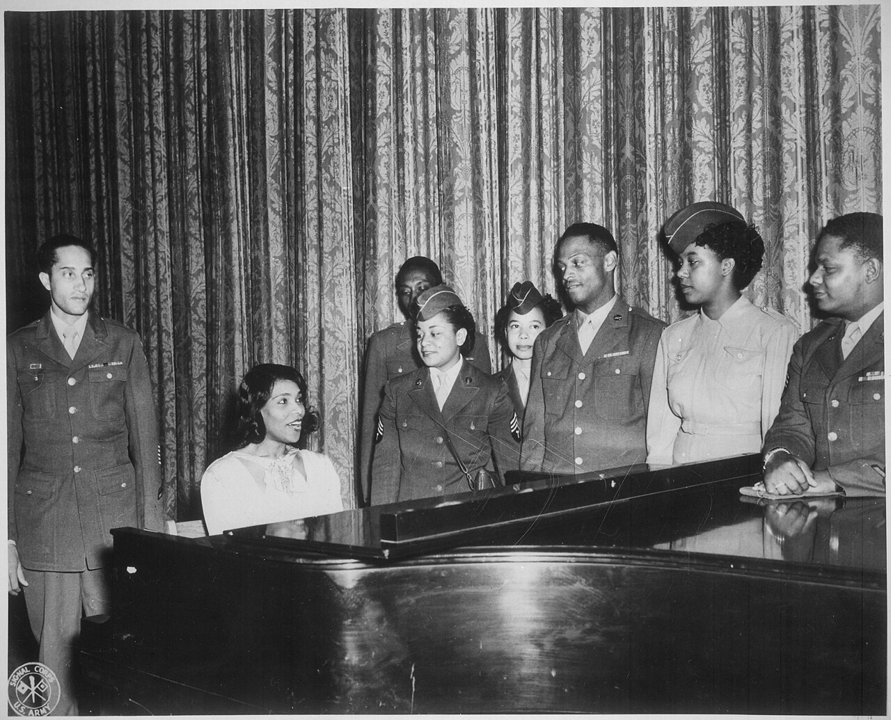 "Marian Anderson, world's greatest contralto, entertains a group of overseas veterans and WACs on (the) stage of the San - NARA