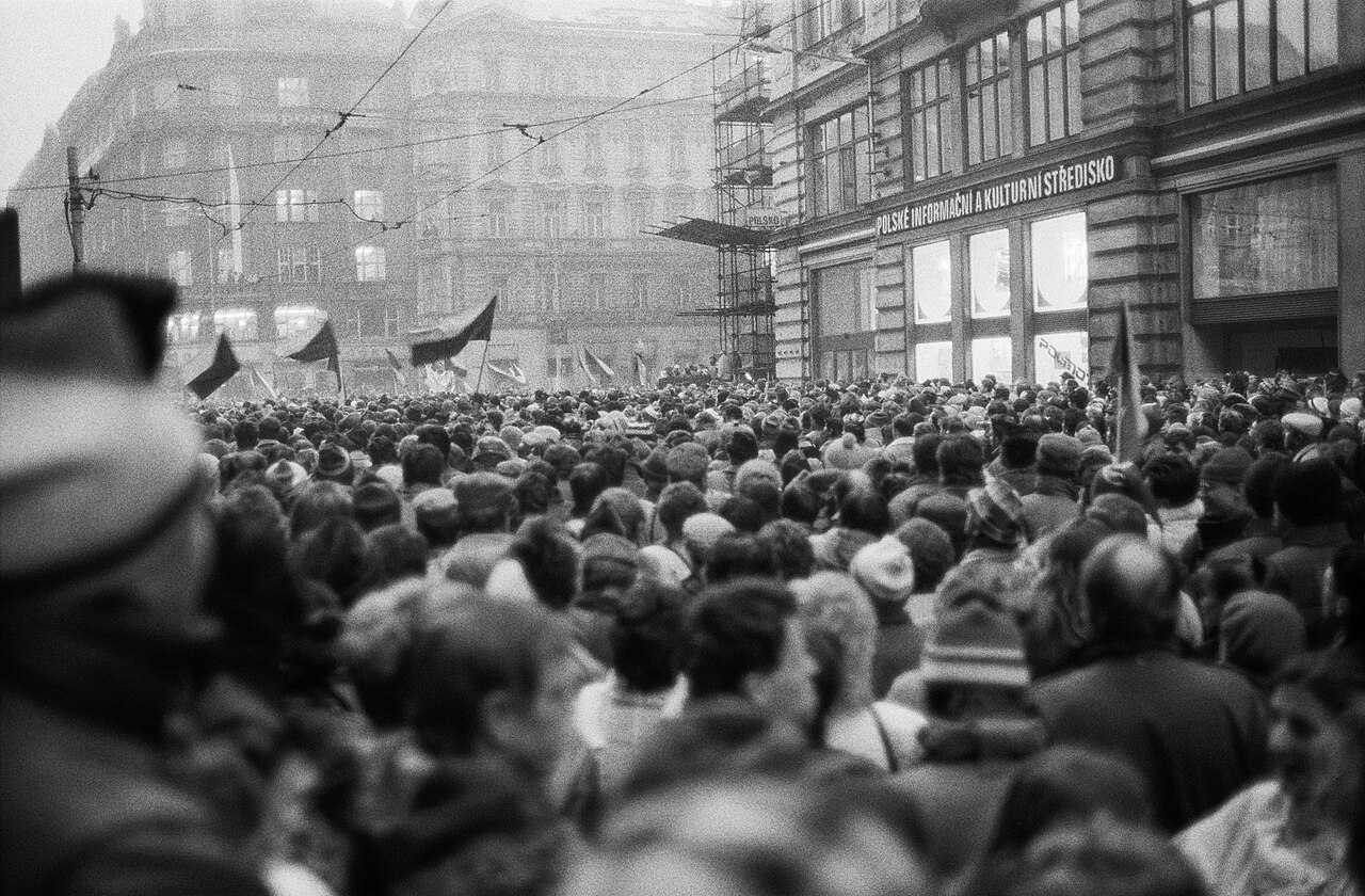 November Prague Velvet Revolution protest crowd with Polish cultural centre in background