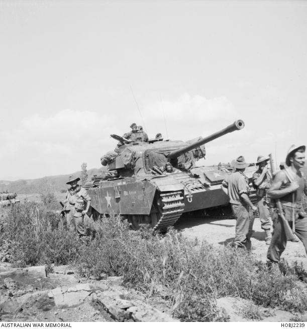 3RAR soldiers advance supported by a British Centurion