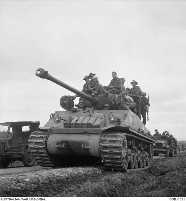 3RAR troops advance on an M4 tank
