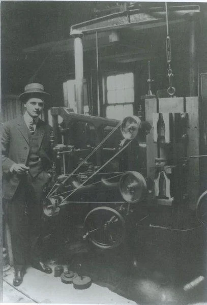 Earl Rollo Dean (1890-1972) with bottle casting machine